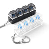 A black plastic fidget toy with multiple clear hexagonal key pieces and attached chains.