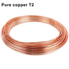 A coil of pure copper T2 wire, consisting of multiple thin, reddish-orange wires coiled into a circular shape.