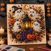 A framed piece of art featuring Halloween ghosts and pumpkins made with 3D pearl embellishments.