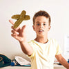 A young boy holds up a realistic squishy prank toy shaped like soft fake poop.
