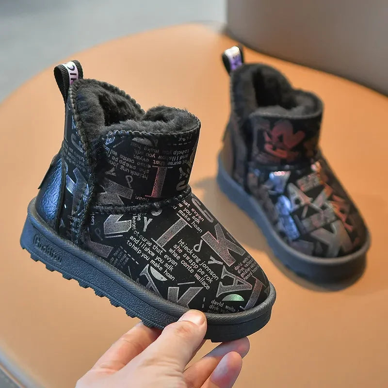 A pair of black winter snow boots with faux fur lining and a non-slip sole being held by a hand.