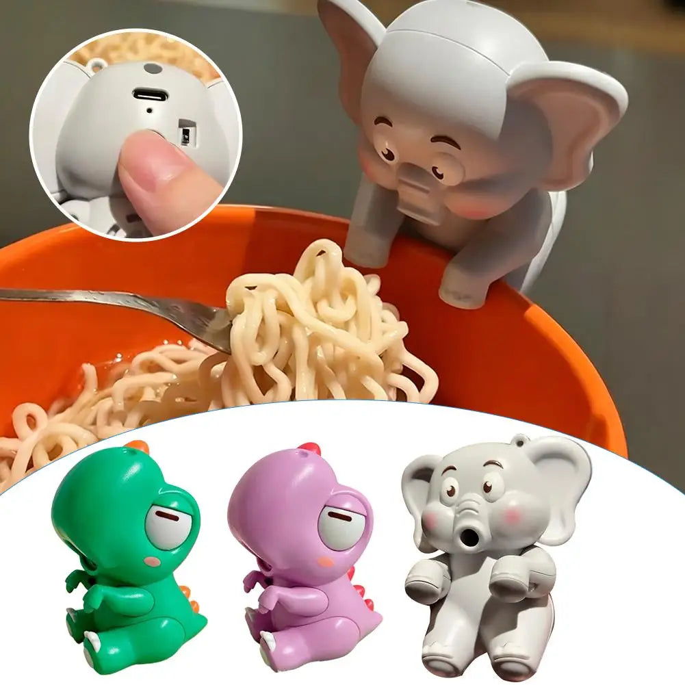 A set of mini elephant toys, including a fan and figures, are shown with uncooked noodles in an orange bowl.