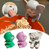 A set of mini elephant toys, including a fan and figures, are shown next to a bowl of noodles.