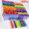 A large box of 100 pack acrylic 6-sided dice in various colors is shown, with a smaller tray of dice in the foreground.