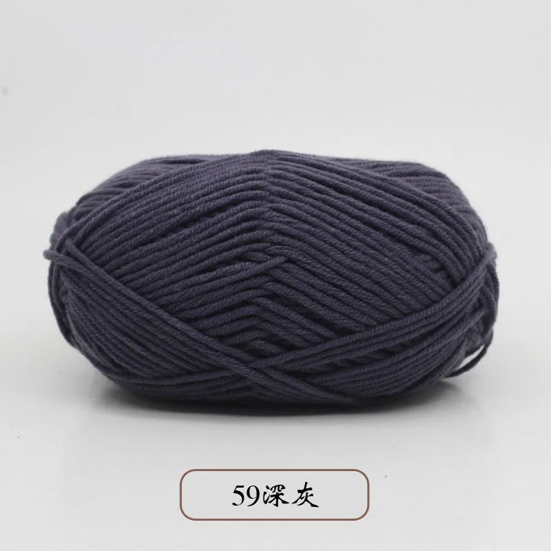 A ball of dark gray pre-dyed milk cotton yarn used for knitting and crochet.