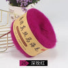 A vibrant magenta silk mohair blended yarn is displayed next to a gold wire rack.