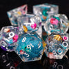 A close-up of a set of sharp edge resin polyhedral dice in various colors and angles.