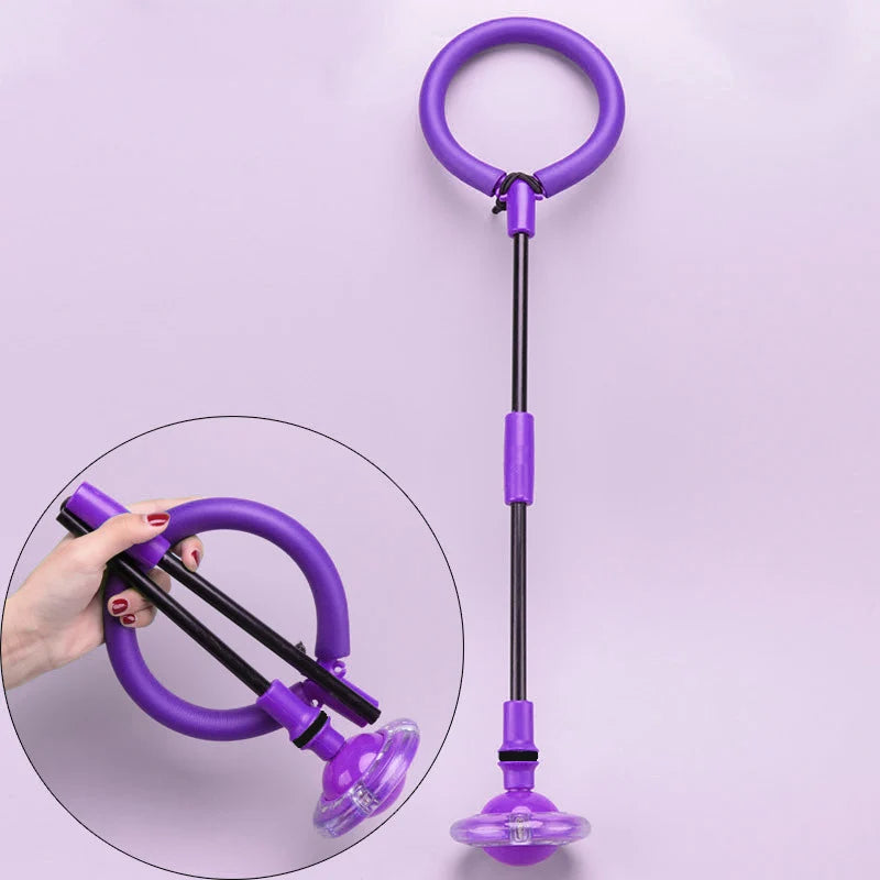 A purple glowing ankle skip ball with a black handle and flashing LED light, shown next to a hand.