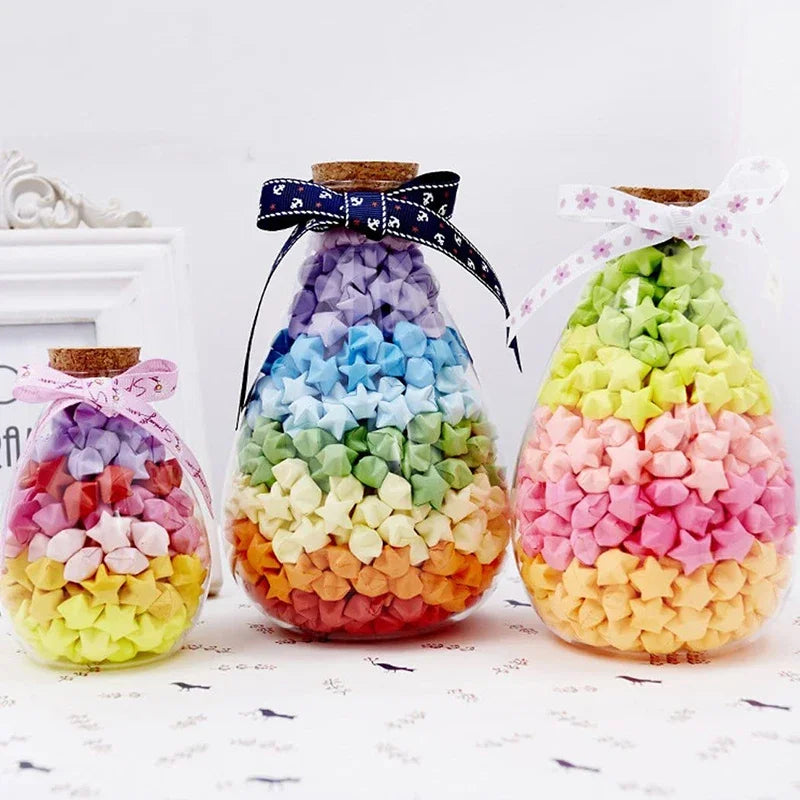 Colorful paper stars arranged in a conical shape tied with ribbon