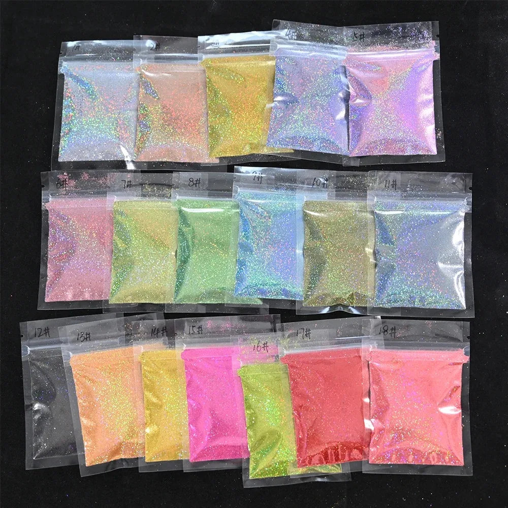 A collection of small plastic bags filled with various colors of holographic rainbow nail glitter dust.