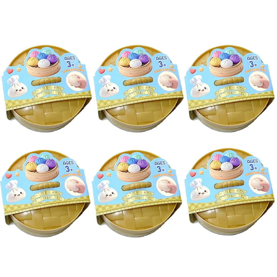 A set of colorful glitter dumpling squishy toys packaged in yellow cardboard boxes for ages 3 and up