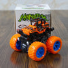 An orange and black monster truck toy sits in its box, featuring large wheels and an off-road vehicle design.