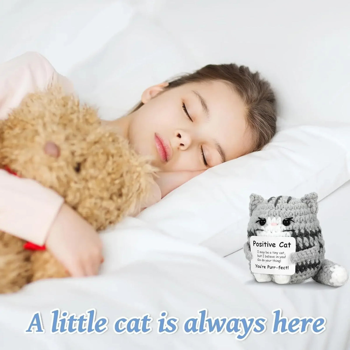 A handmade crochet cat figurine with a smiling face resting on white bedding.