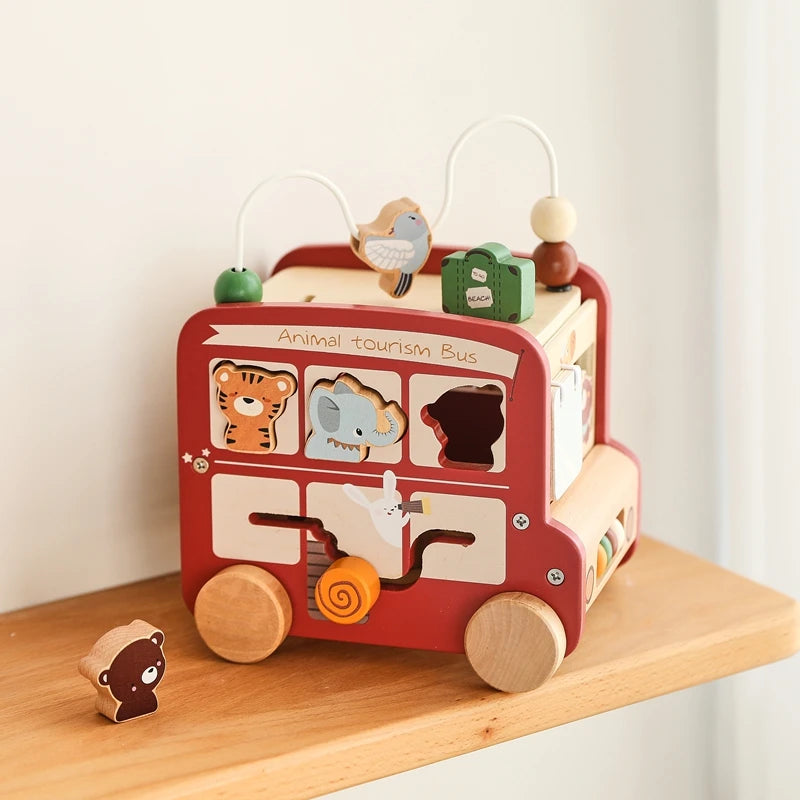A wooden animal tourism bus Montessori busy board for toddlers featuring various animals and elements.