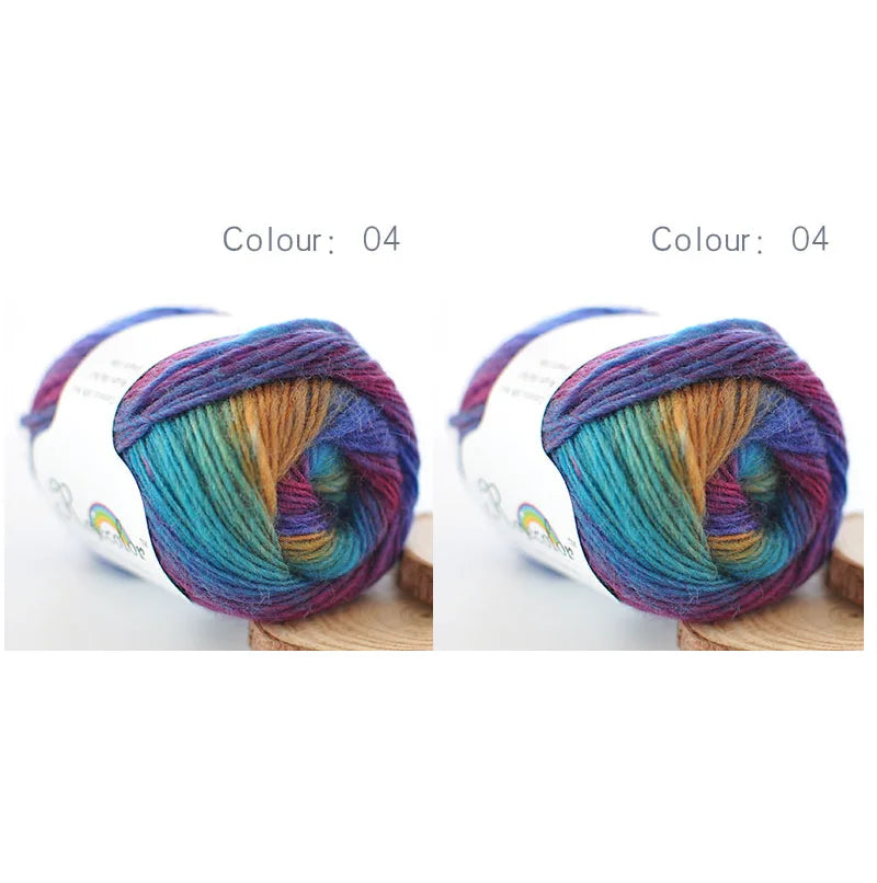 A ball of hand-dyed rainbow merino wool yarn in shades of blue, purple, and green.