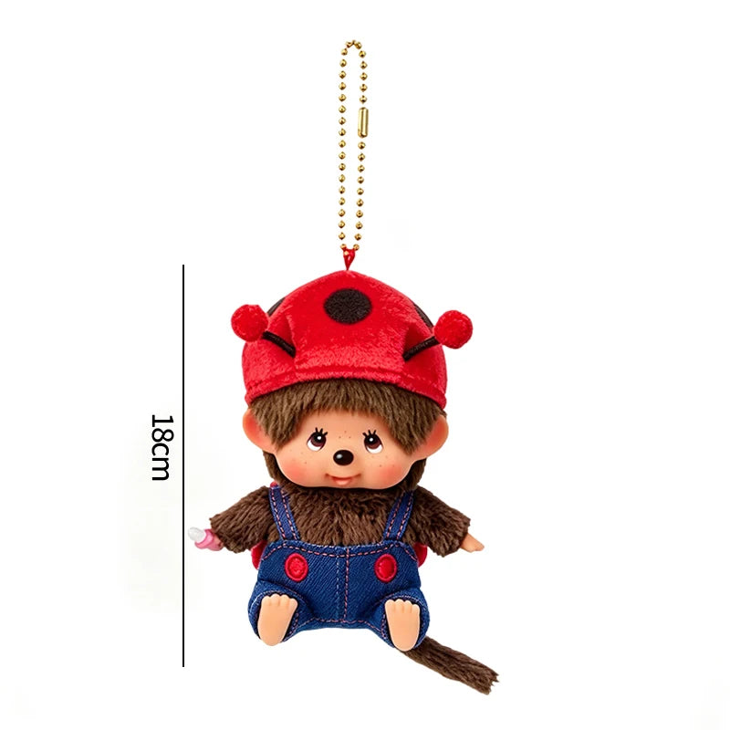 A red cartoon plush character with a black nose and brown fur wearing a blue vest, attached to a gold chain.