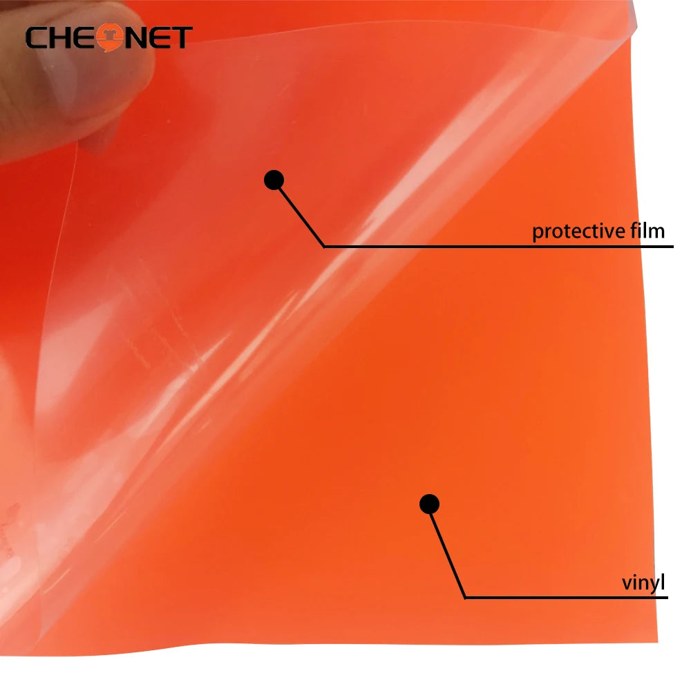A sheet of orange vinyl film showing a protective film layer and the underlying vinyl material.