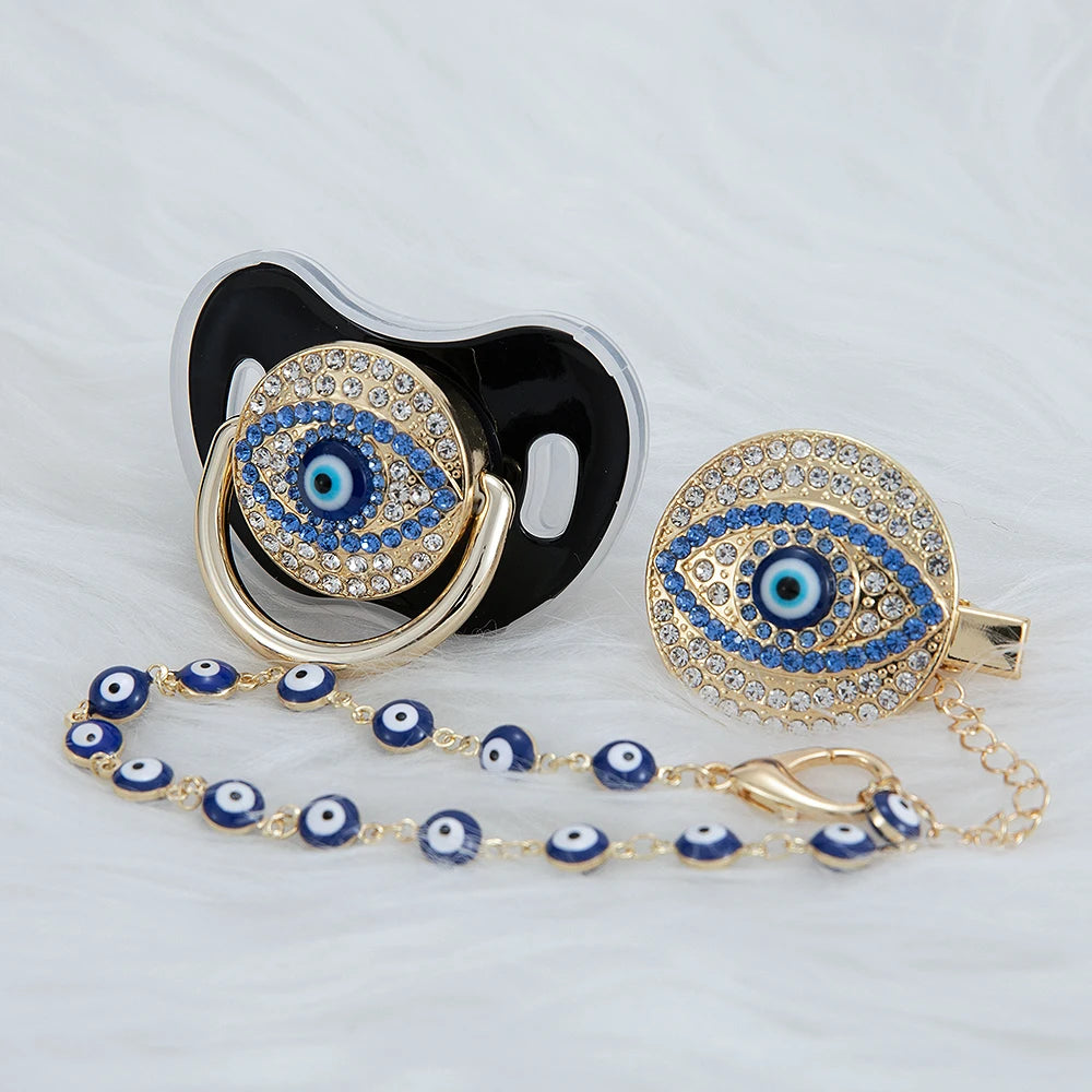 Gold and blue evil eye pacifier and clip set with a black silicone holder