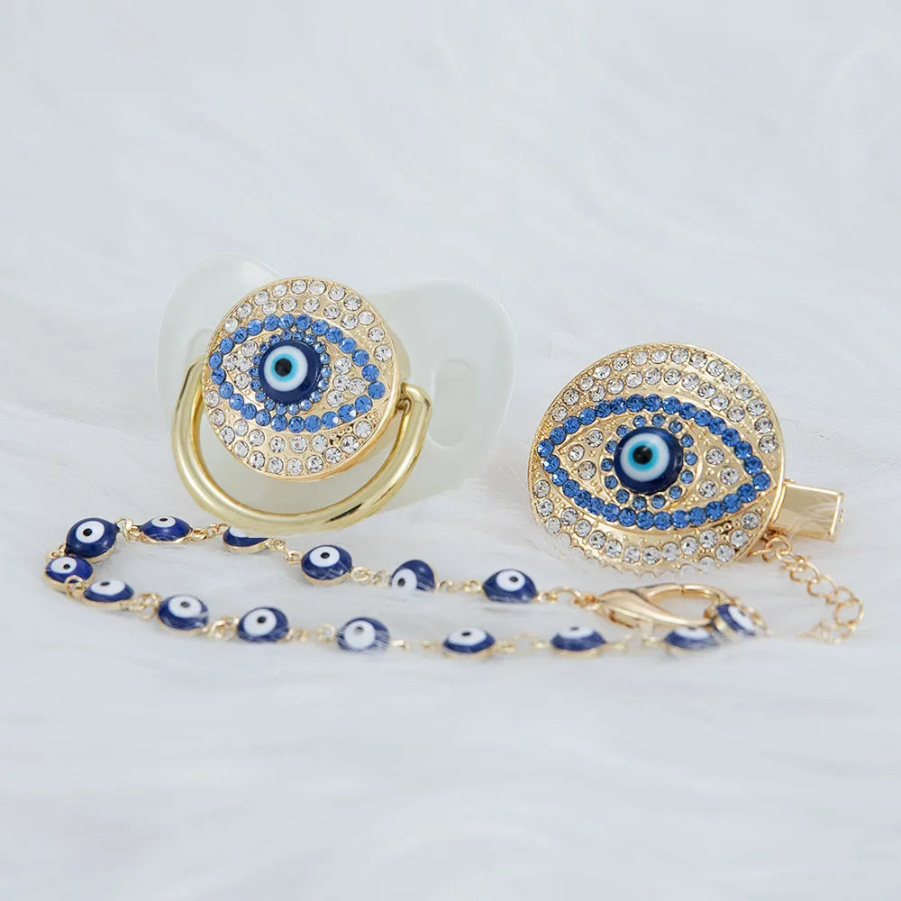 Gold and blue evil eye pacifier and clip set with a large eye charm