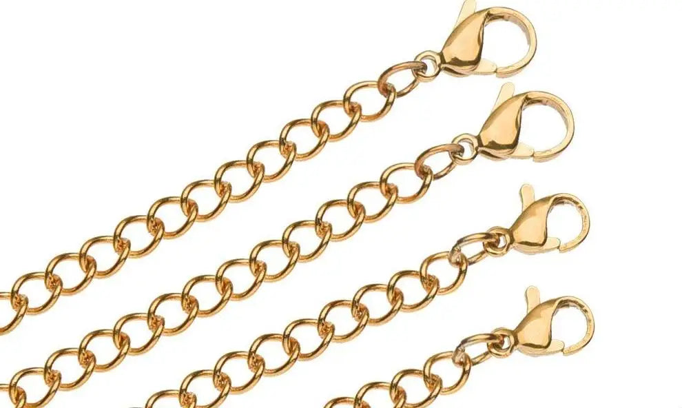 A collection of gold-toned stainless steel jewelry extender chains with lobster clasps.