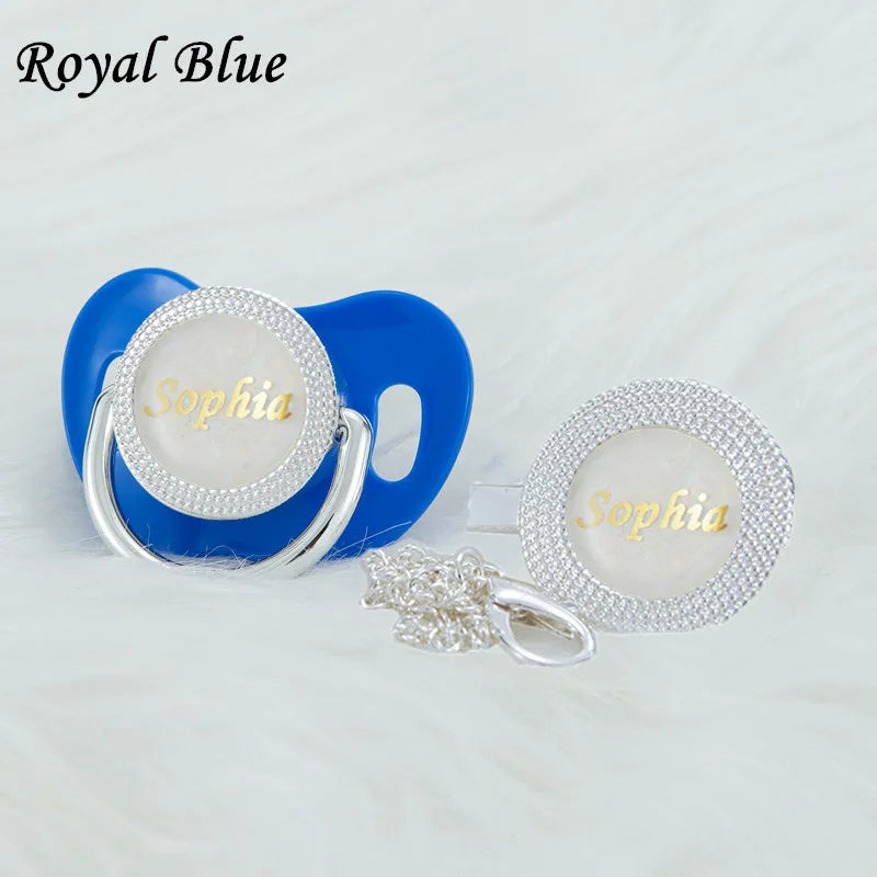 Royal blue pacifier and clip set with a white rhinestone disc and silver chain