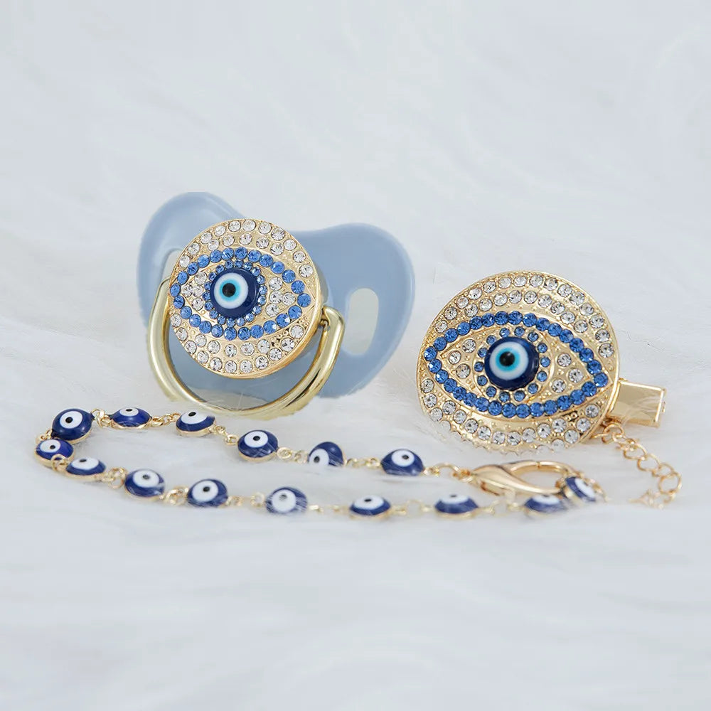 Gold and blue evil eye pacifier and clip set with a light blue silicone holder